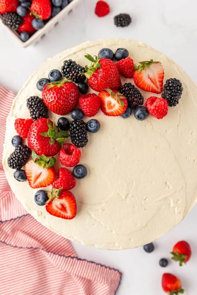 top down view of chantilly cake decorated with fresh berries