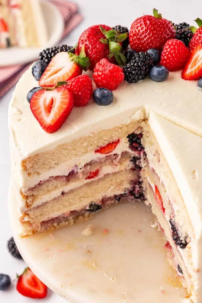 whole chantilly cake with a few slices missing so you can see the inside