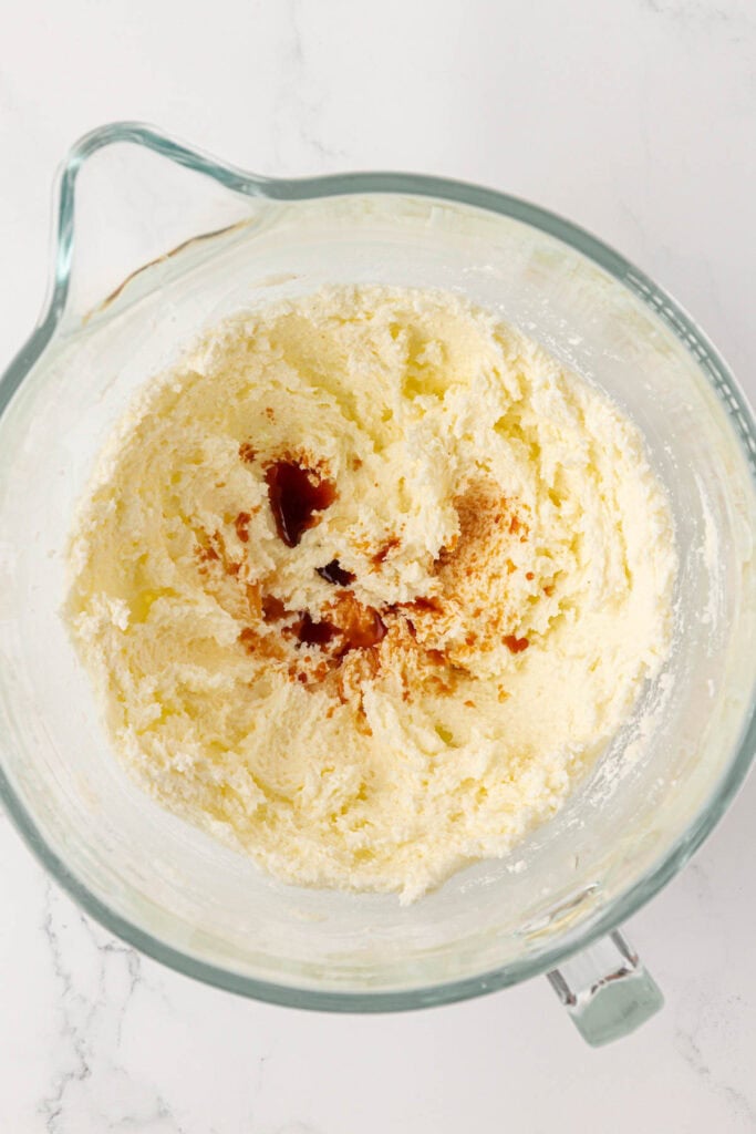vanilla and almond extract added to creamed butter mixture