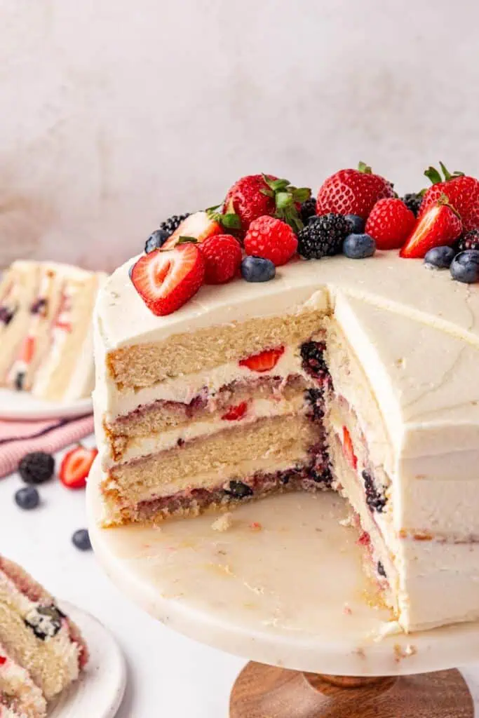 whole Chantilly cake with a slice missing