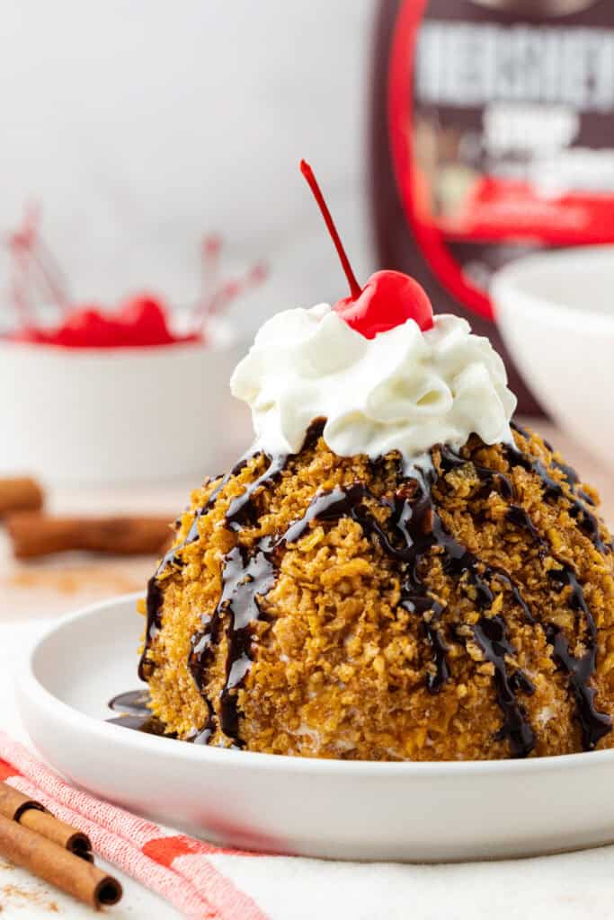 mexican fried ice cream serving on a plate with toppings