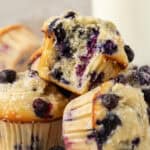 three buttermilk blueberry muffins stacked on top of each other