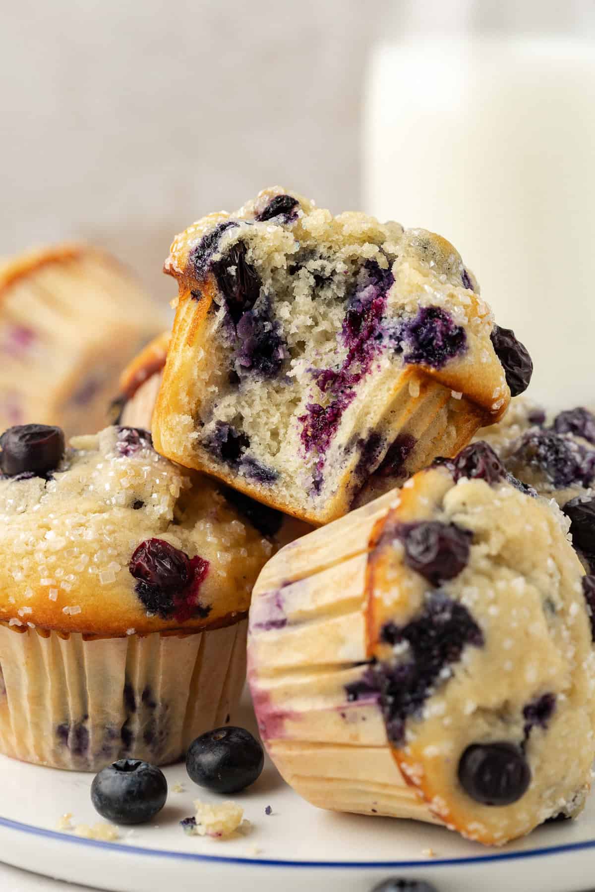 three buttermilk blueberry muffins stacked on top of each other