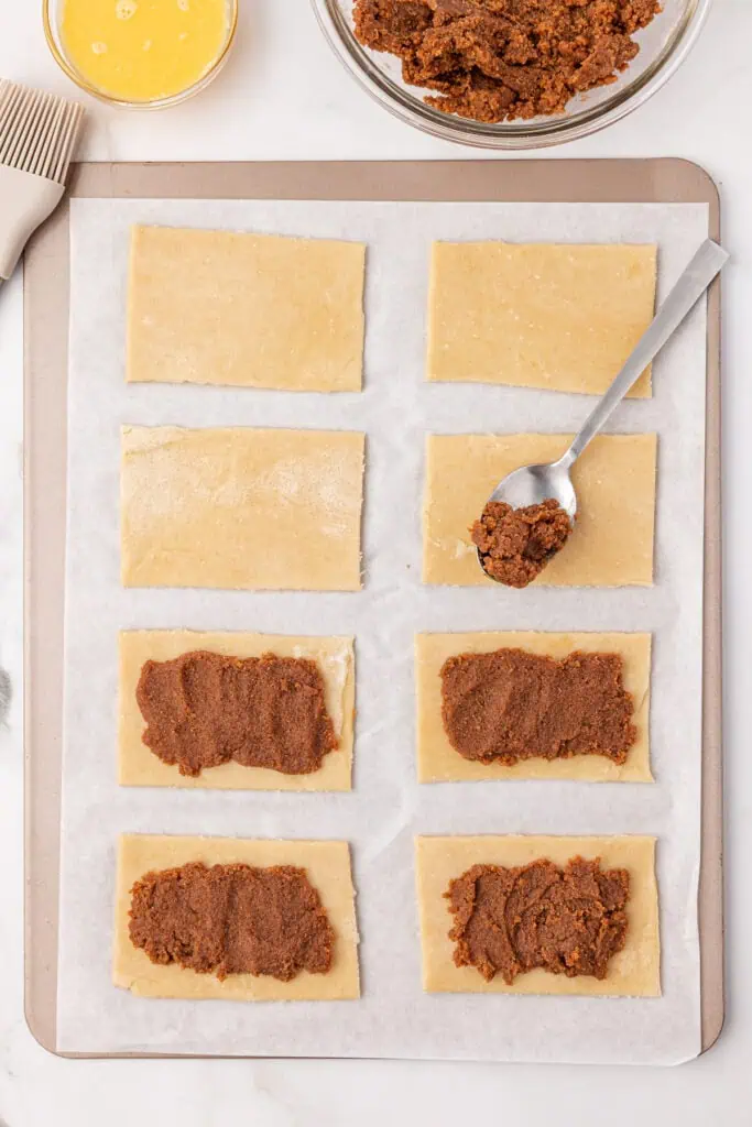 spoon adding filling to the pop tart squares