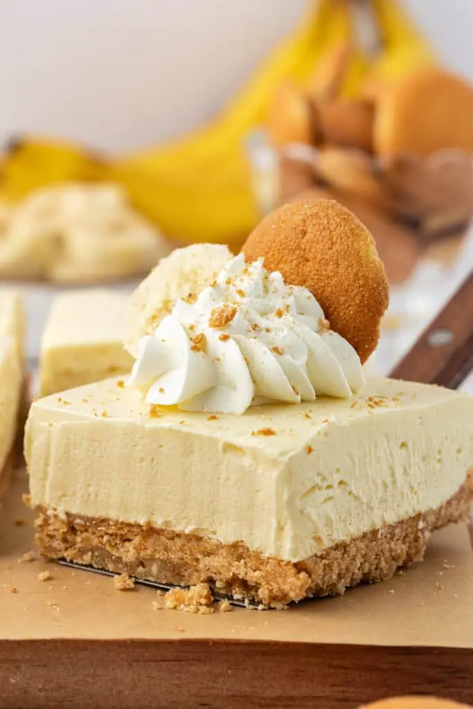 no bake banana pudding cheesecake bar topped with whipped cream