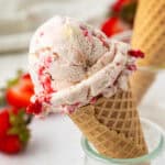 strawberry cheesecake ice cream in a cone