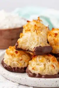 coconut macaroons stacked on top of each other with one having a bite taken out of it