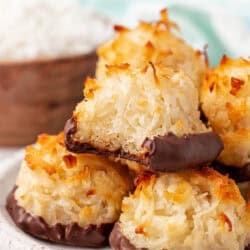 coconut macaroons stacked on top of each other with one having a bite taken out of it
