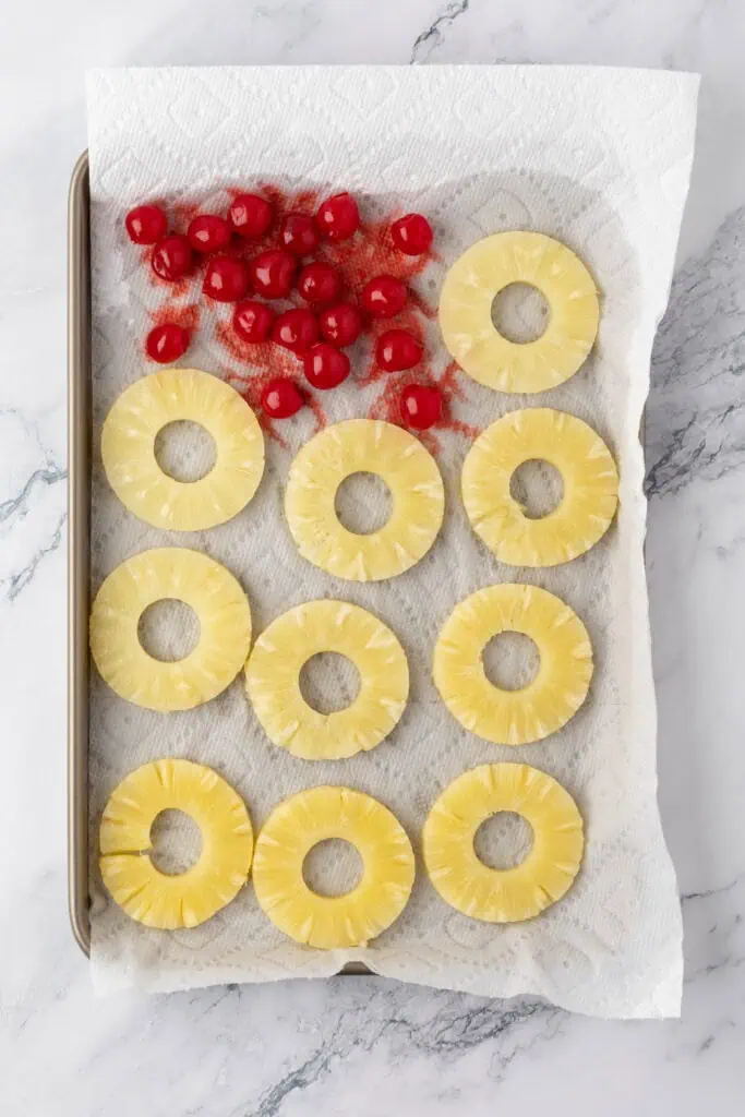 pineapple rings and cherries on a paper towel