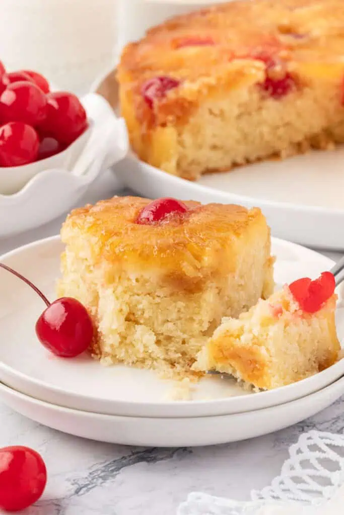 slice of pineapple upside down cake with a bite missing