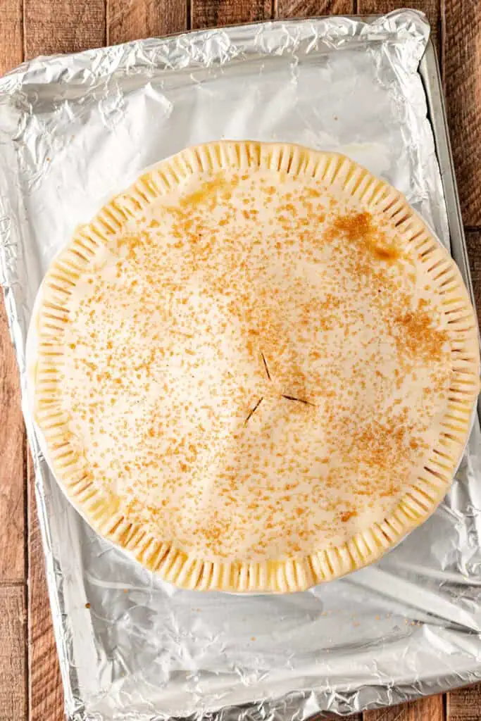 apple pie unbaked on a baking sheet