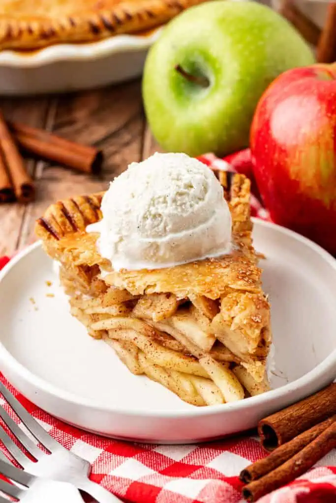 slice of apple pie topped with ice cream