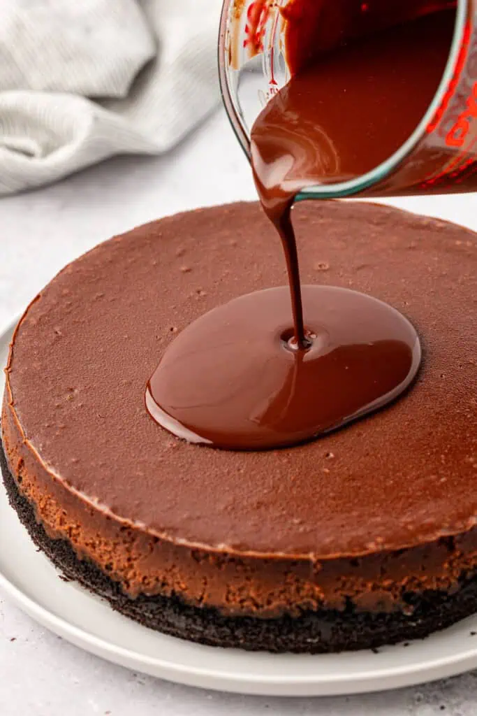 ganache poured over the cheesecake