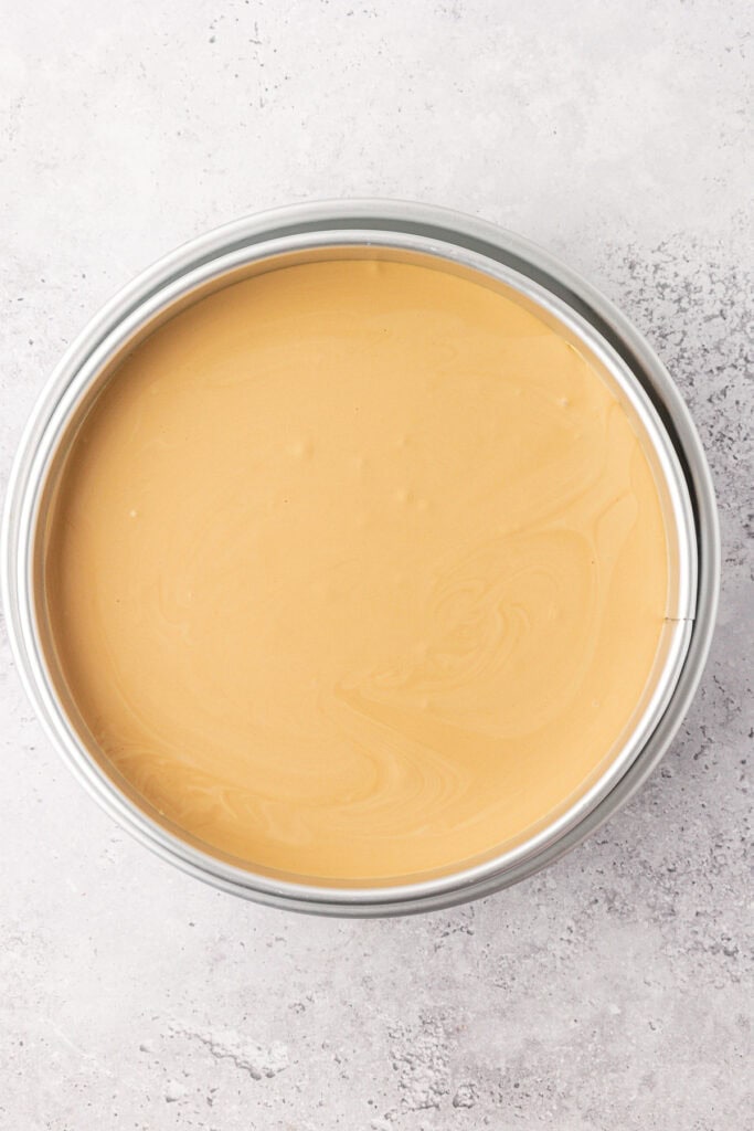 unbaked espresso cheesecake in a large cake pan