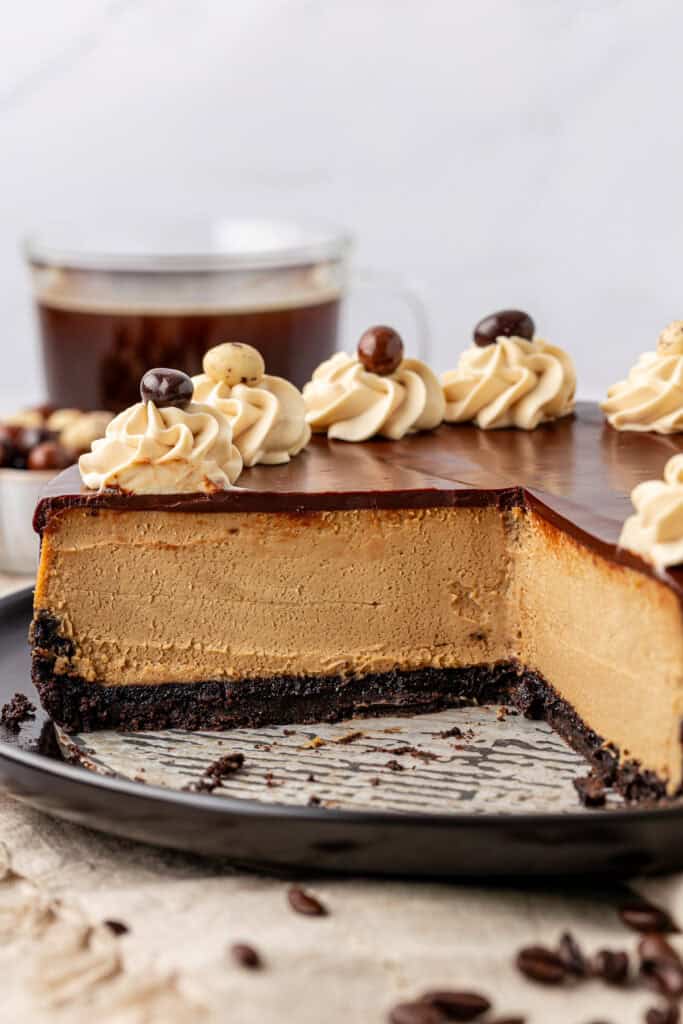 whole espresso cheesecake with slices missing