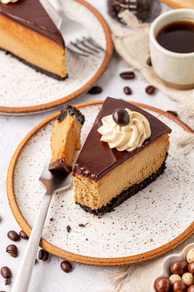espresso cheesecake slice with a fork on a plate