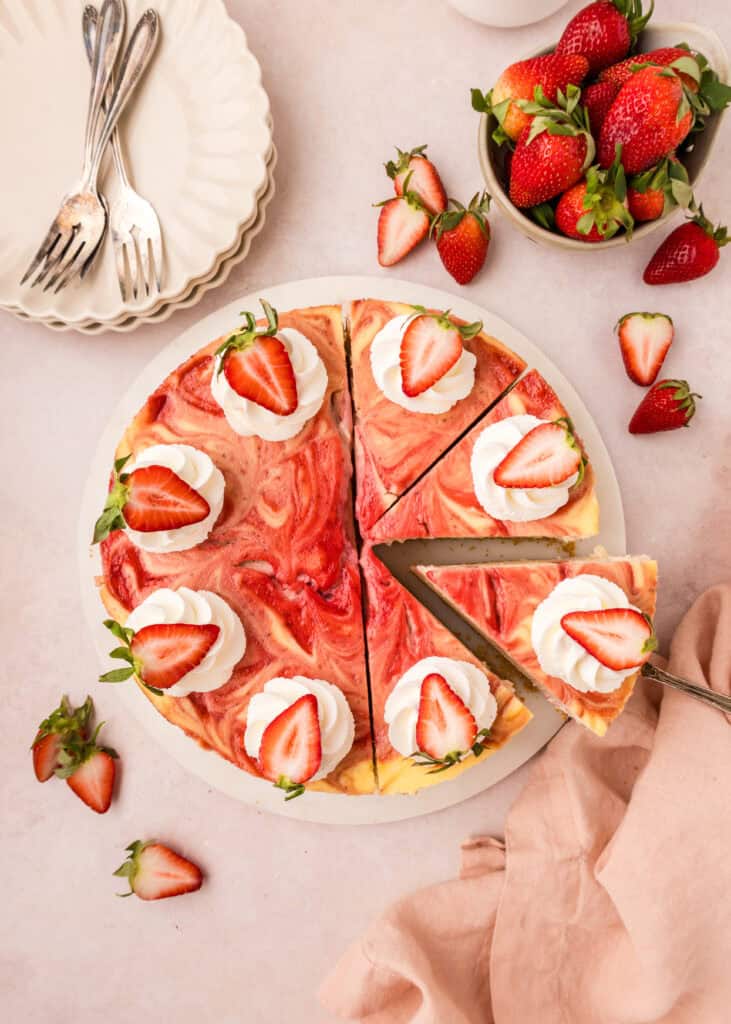top down view of a whole baked strawberry swirl cheesecake