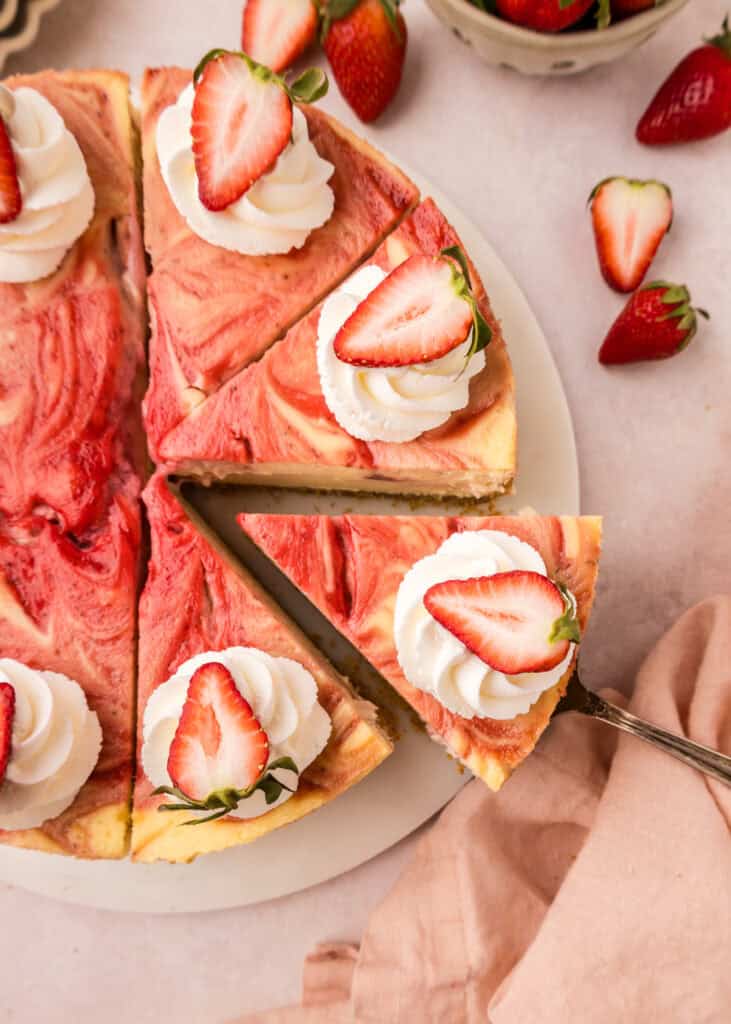 top down view of cheesecake with slice being pulled away 
