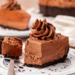 slice of no bake chocolate cheesecake with a forkful missing