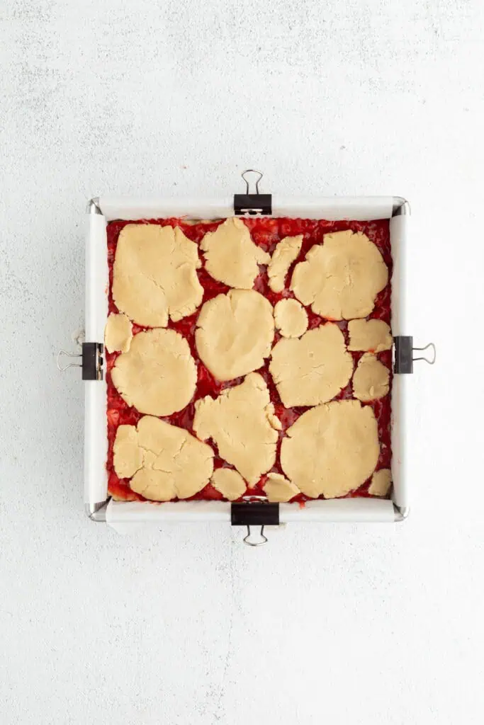 remaining cookie dough pressed on top of strawberry jam