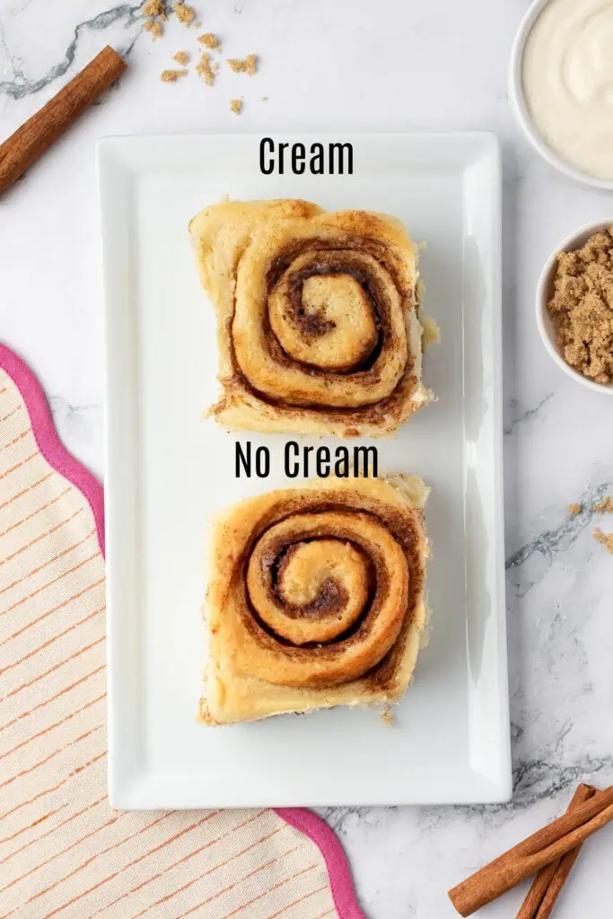 two cinnamon rolls showing the bottom, one with cream and one without