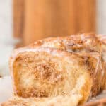 cinnamon pull apart bread loaf with a piece missing to show the interior