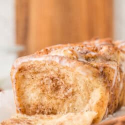 cinnamon pull apart bread loaf with a piece missing to show the interior
