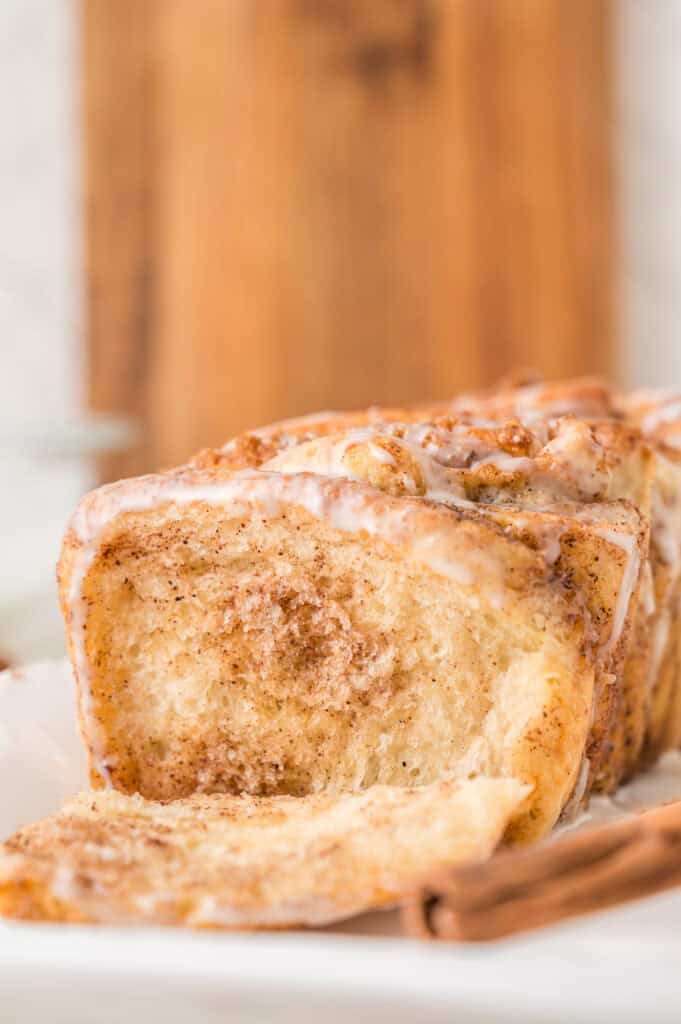 cinnamon pull apart bread loaf with a piece missing to show the interior