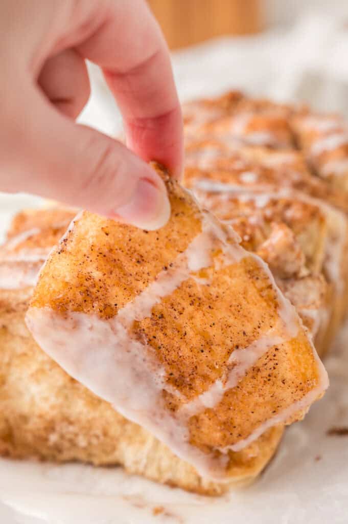 hand holding a piece of the cinnamon pull apart bread