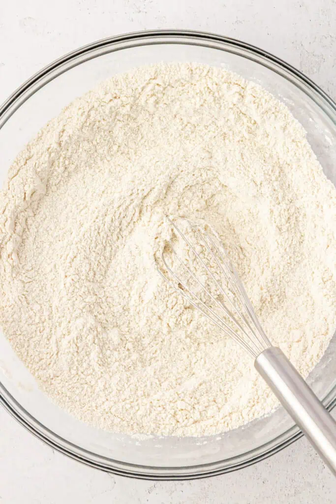 dry ingredients for peach crumb bars in a bowl with a whisk