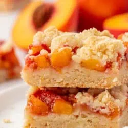 two peach crumb bars stacked on each other