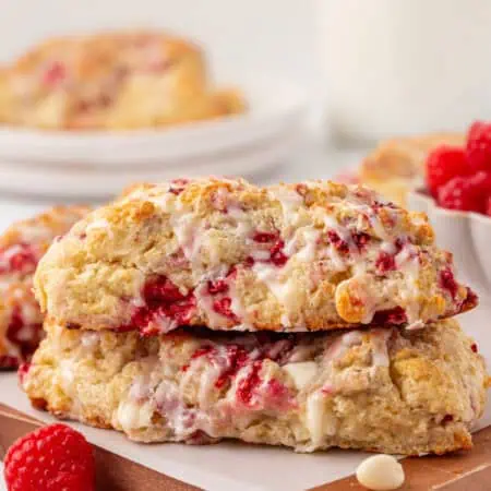 two white chocolate raspberry scones stacked on a plate