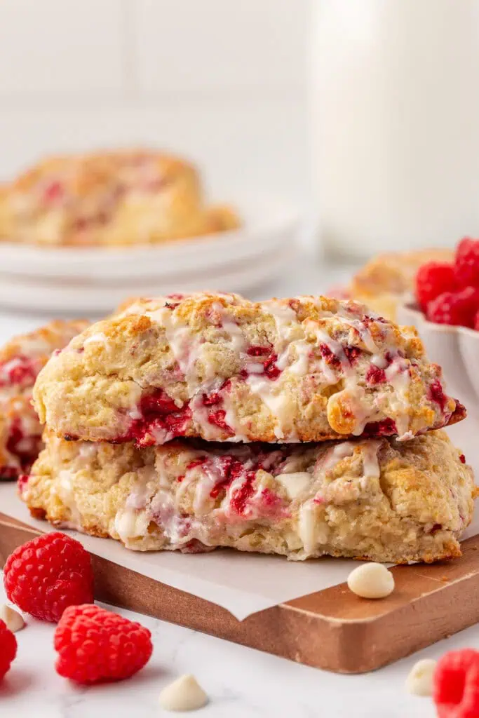 two white chocolate raspberry scones stacked on a plate