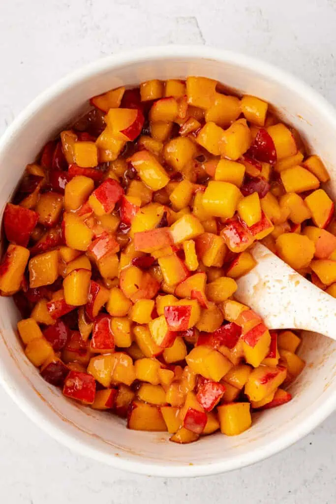 peach mixture in a bowl with a spatula