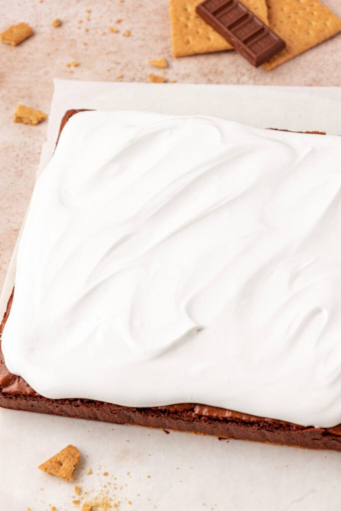 marshmallow meringue frosting spread on top of brownies