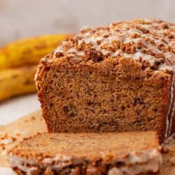a loaf of brown butter banana bread with a slice cut