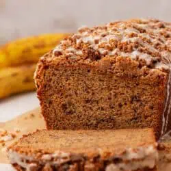 a loaf of brown butter banana bread with a slice cut