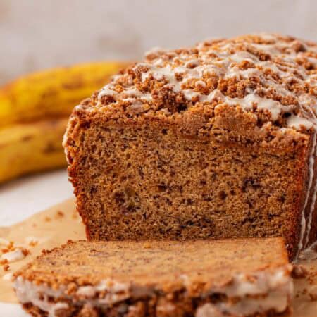 a loaf of brown butter banana bread with a slice cut