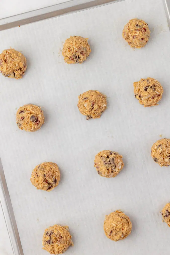 cowboy cookie dough balls on a cookie sheet