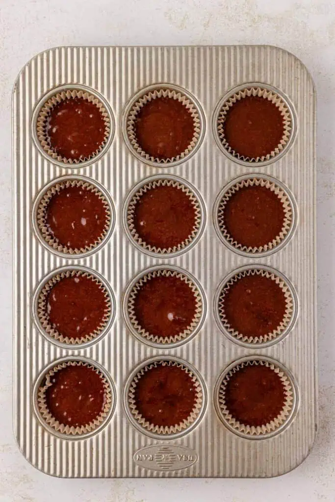 unbaked chocolate cupcake batter in cupcake pan