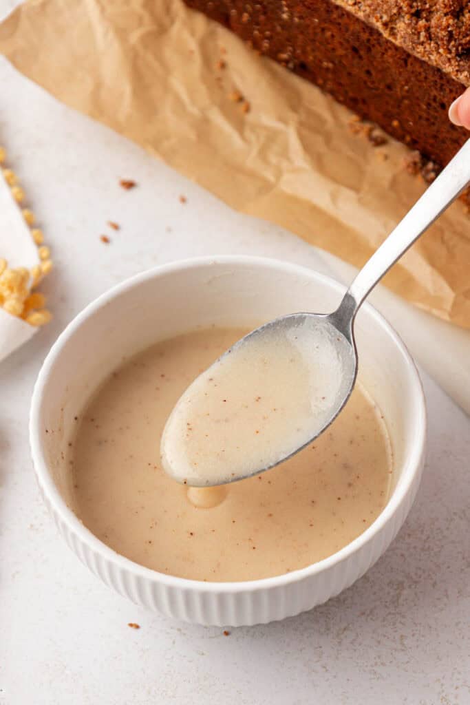 bowl of browned butter glaze with a spoon
