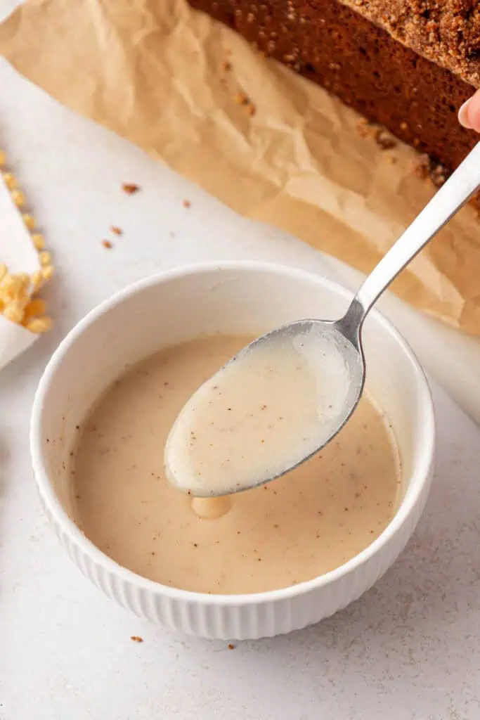 bowl of browned butter glaze with a spoon