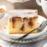slice of cinnamon roll cake on a plate with a fork