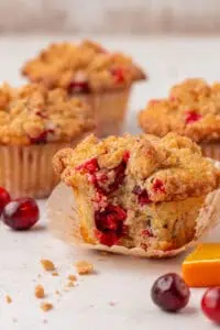 cranberry orange muffin with a bite taken out of it