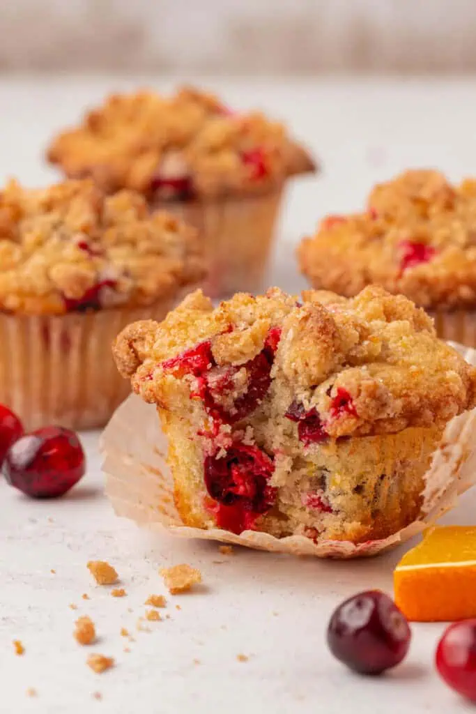 cranberry orange muffin with a bite taken out of it
