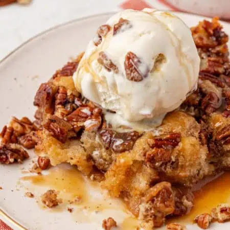 a scoop of pecan pie cobbler with ice cream on top