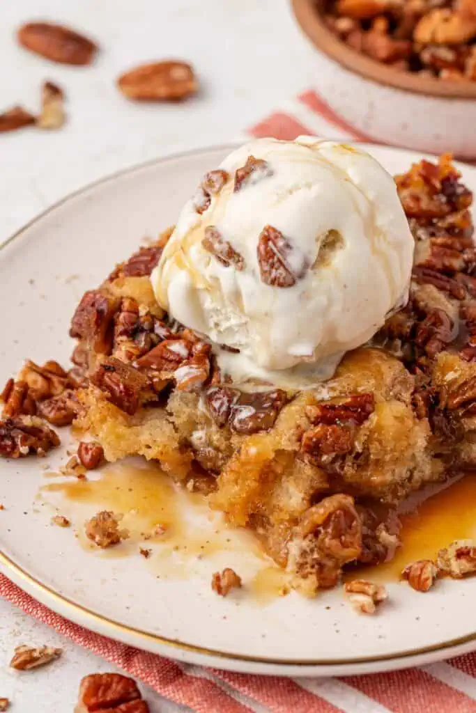 a scoop of pecan pie cobbler with ice cream on top