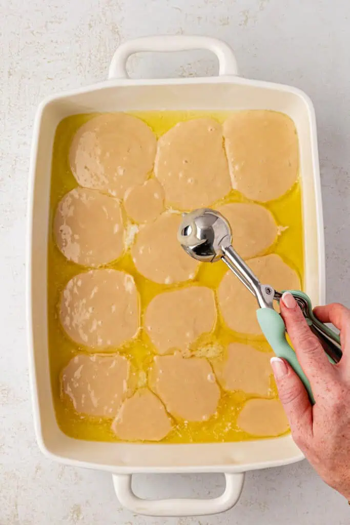 batter dolloped over the melted buttr