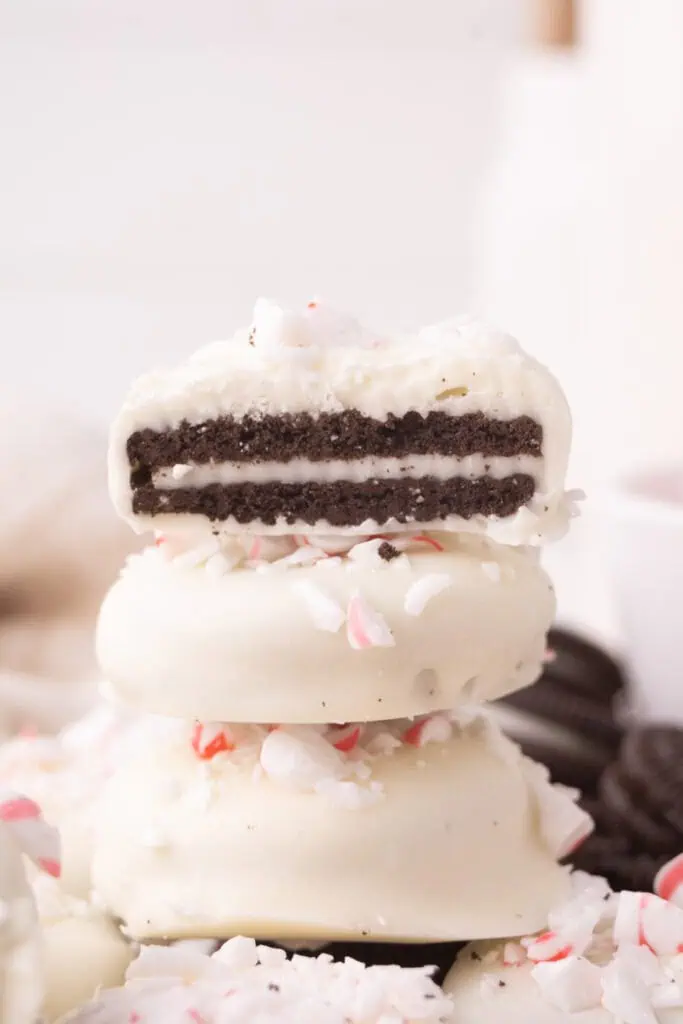 three peppermint bark oreos stacked with top oreo cut in half