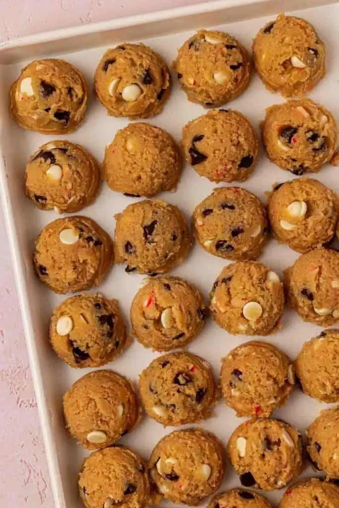 cookie dough balls on a cookie sheet
